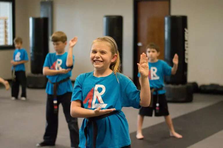 Students training strikes and blocks in kids karate class at Rise Martial Arts