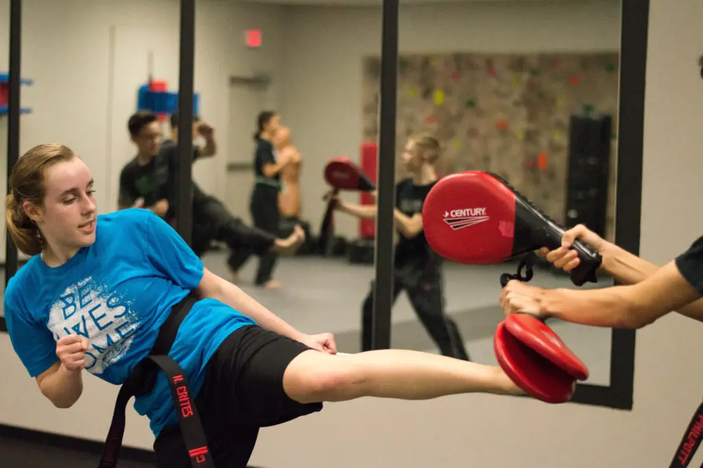 Teen using Karate kick during class in pflugerville TX